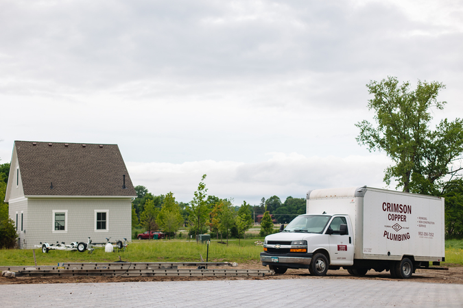 plumbing truck in front of a house