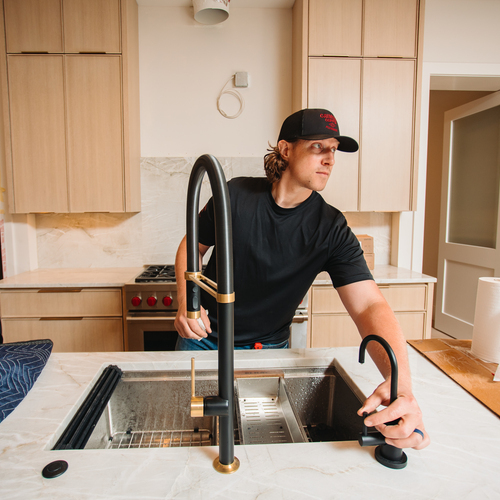 plumber working on kitchen remodeling