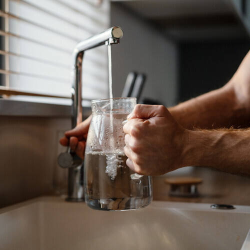 pouring water into a jug